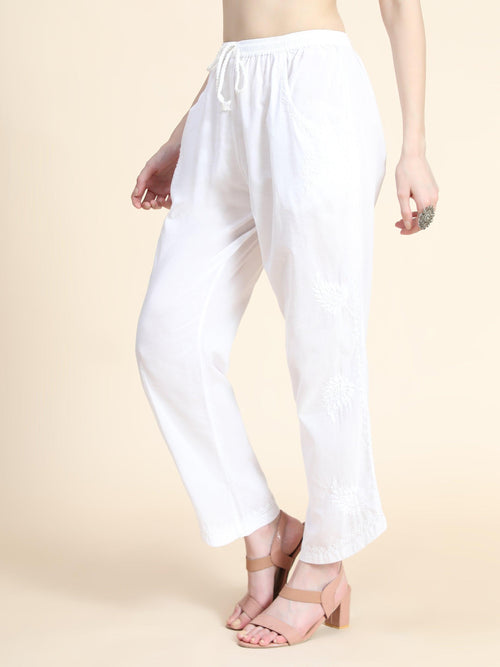 Close-up of intricate hand embroidery on a white Chikankari Pant. Features breathable cotton lycra bottom pants.