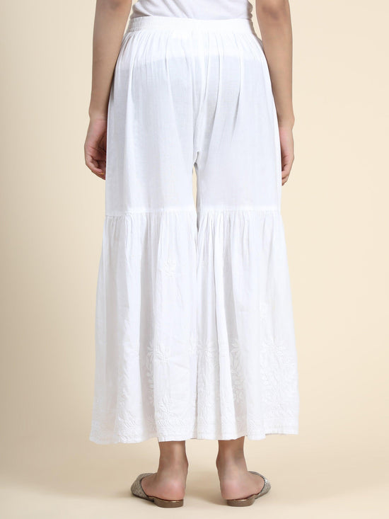 Back view the flowing elegance of a white Chikankari Garara. Cotton rayon fabric, perfect bottom wear for women.