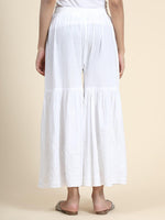 Back view the flowing elegance of a white Chikankari Garara. Cotton rayon fabric, perfect bottom wear for women.