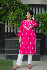 Front view of a peach Chikankari short kurta for women in cotton with hand embroidery. Ideal for summer casual wear.