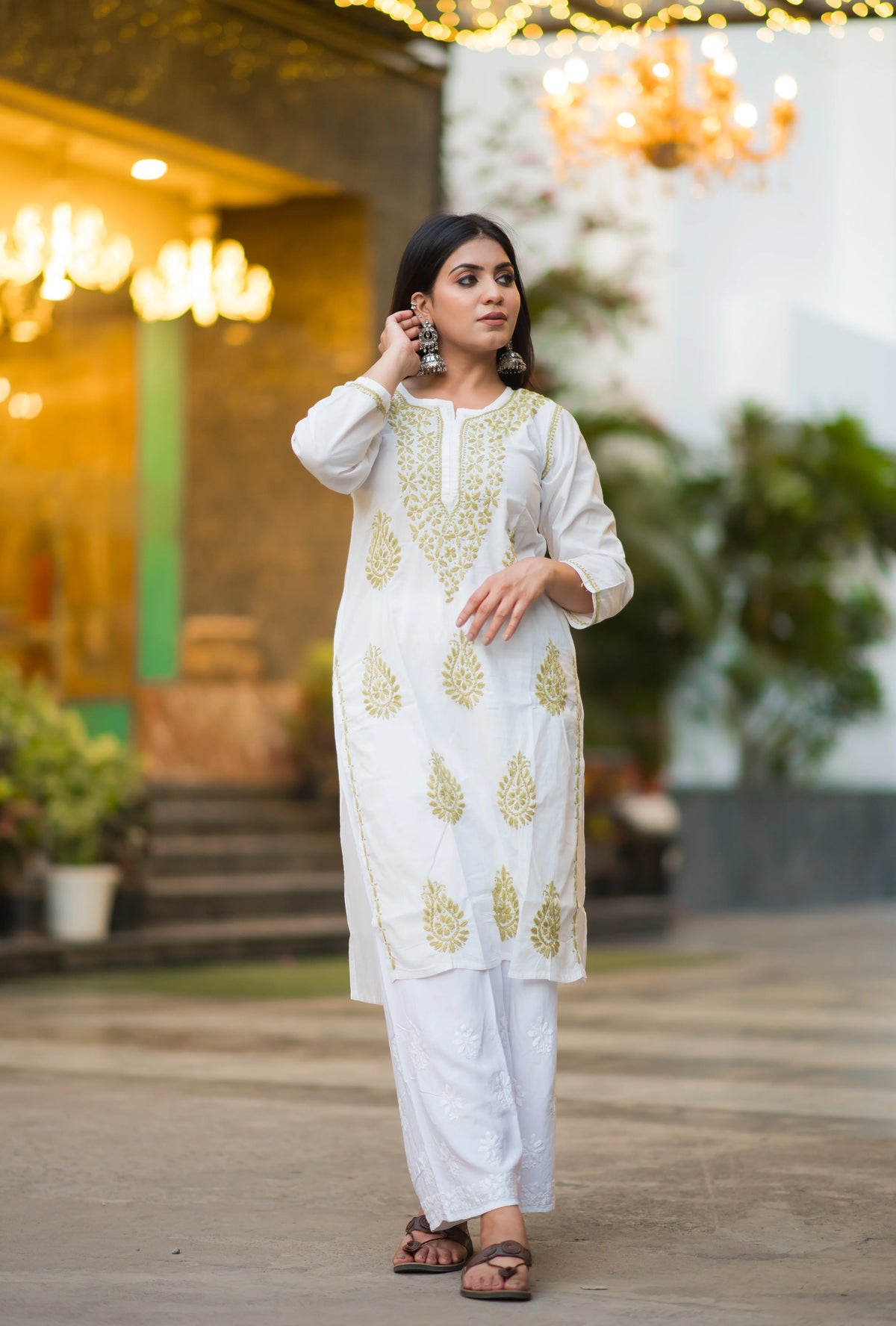 Side view of Snapfab's timeless white Chikankari kurta and palazzo set, crafted from soft cotton with elegant beige thread work.