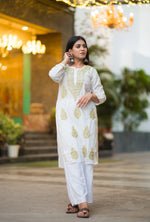 Side view of Snapfab's timeless white Chikankari kurta and palazzo set, crafted from soft cotton with elegant beige thread work.