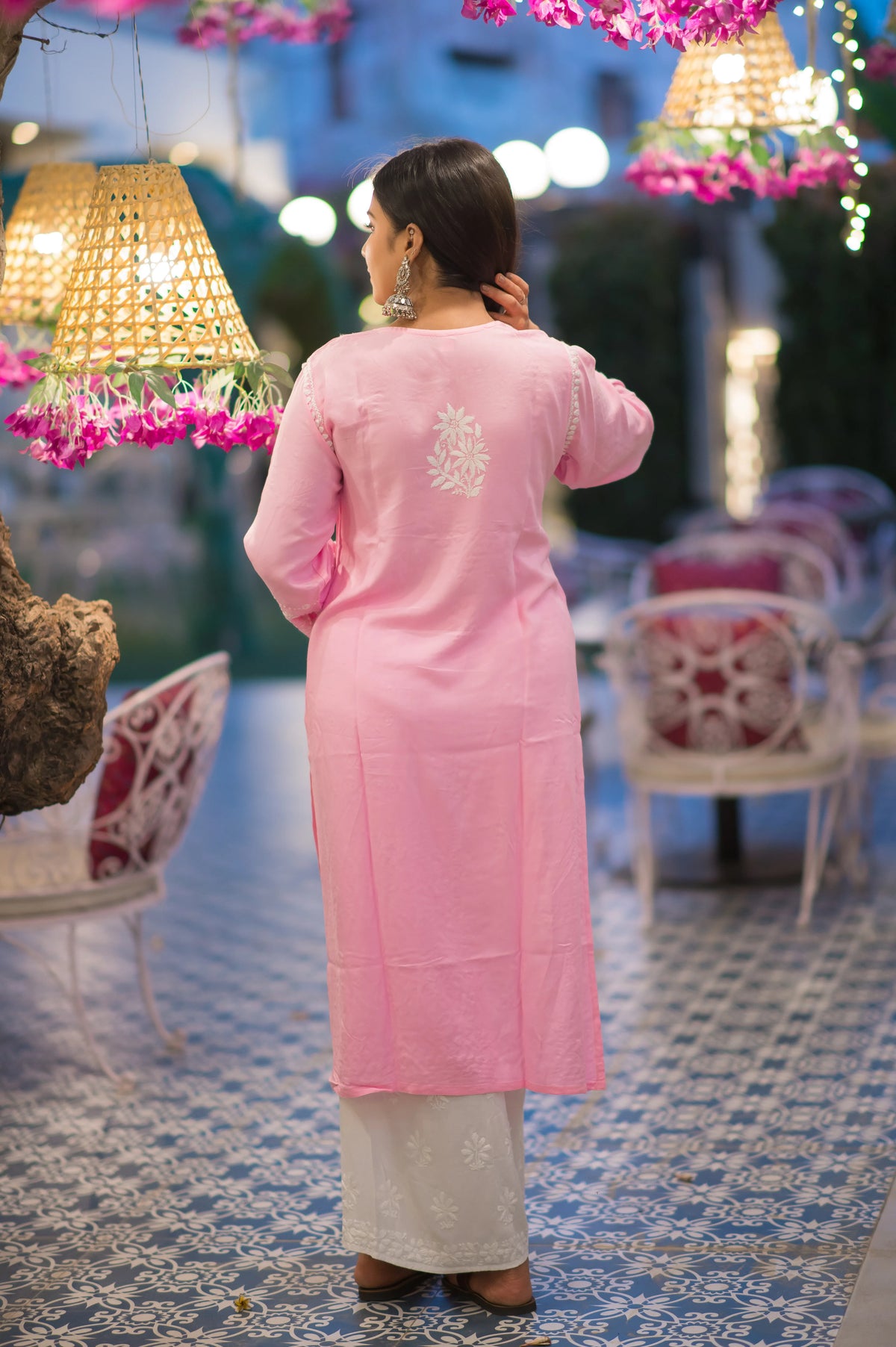 Back view showcasing delicate white floral Chikankari embroidery on soft pink cotton kurti; elegant and refined appeal.