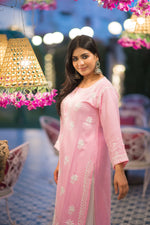 Side view of pastel pink Chikankari kurti with intricate white floral embroidery