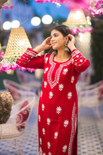 Angled view of a woman in a classic red kurta, highlighting the white embroidered pattern.