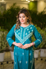 A close-up front view shows a woman in a teal blue kurta featuring detailed white thread embroidery.