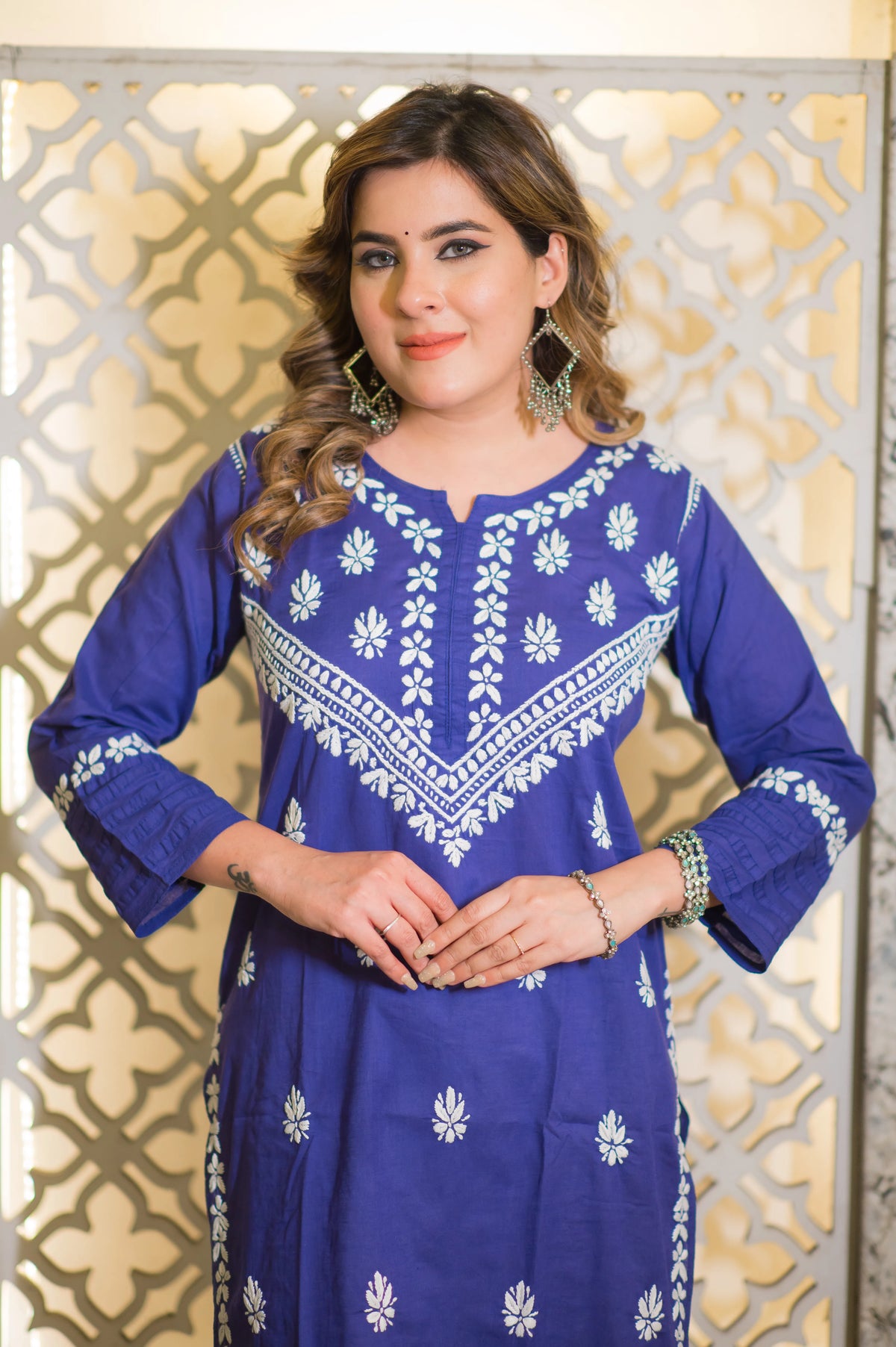 Front view of the white intricate embroidery on a blue chikankari kurta.