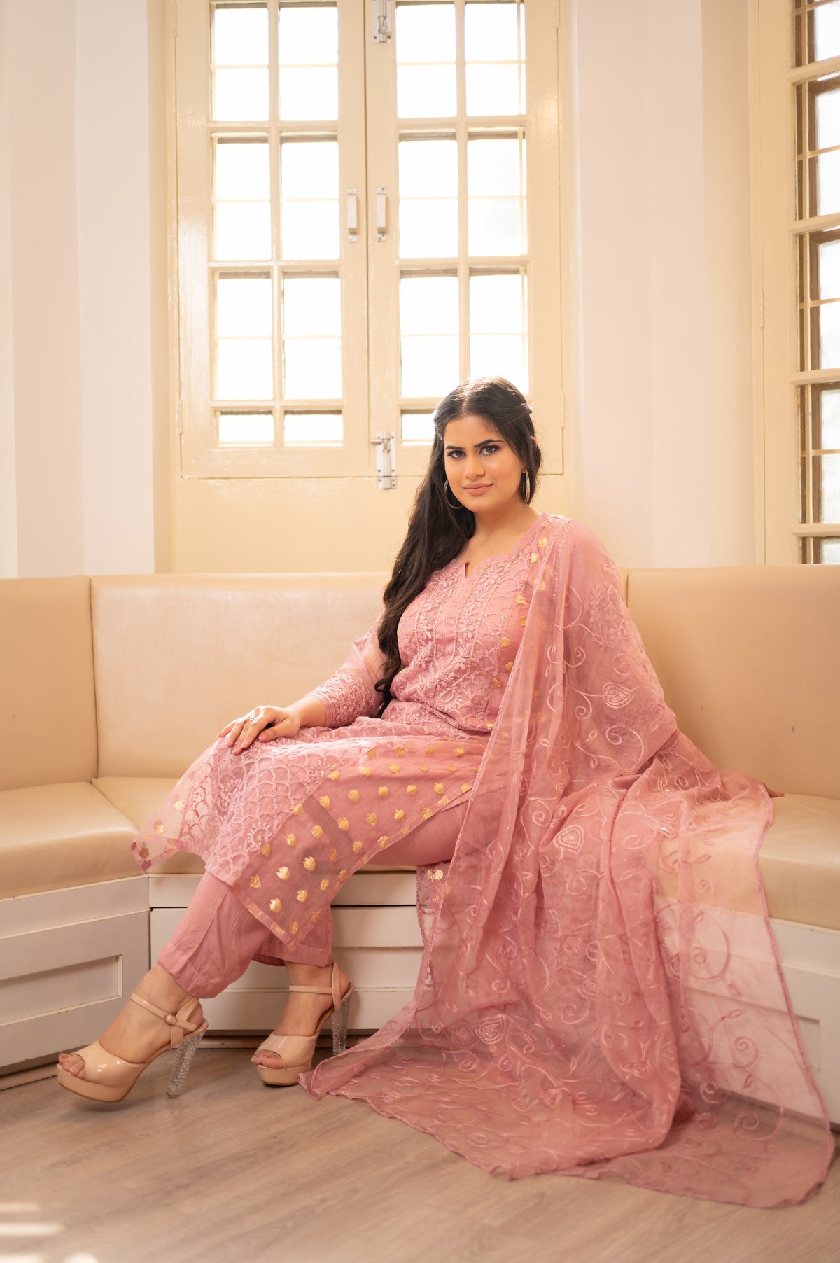 Front view in a trendy pink organza salwar suit, embroidered. Perfect festive wear, Indian fashion.