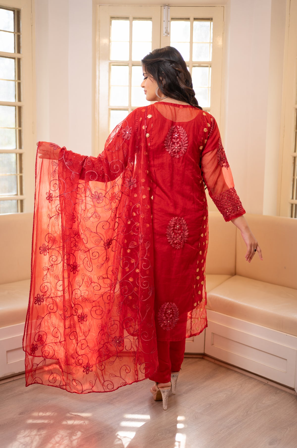 Back view Red net salwar kameez with intricate design. View beautiful organza fabric, perfect for Indian fashion.