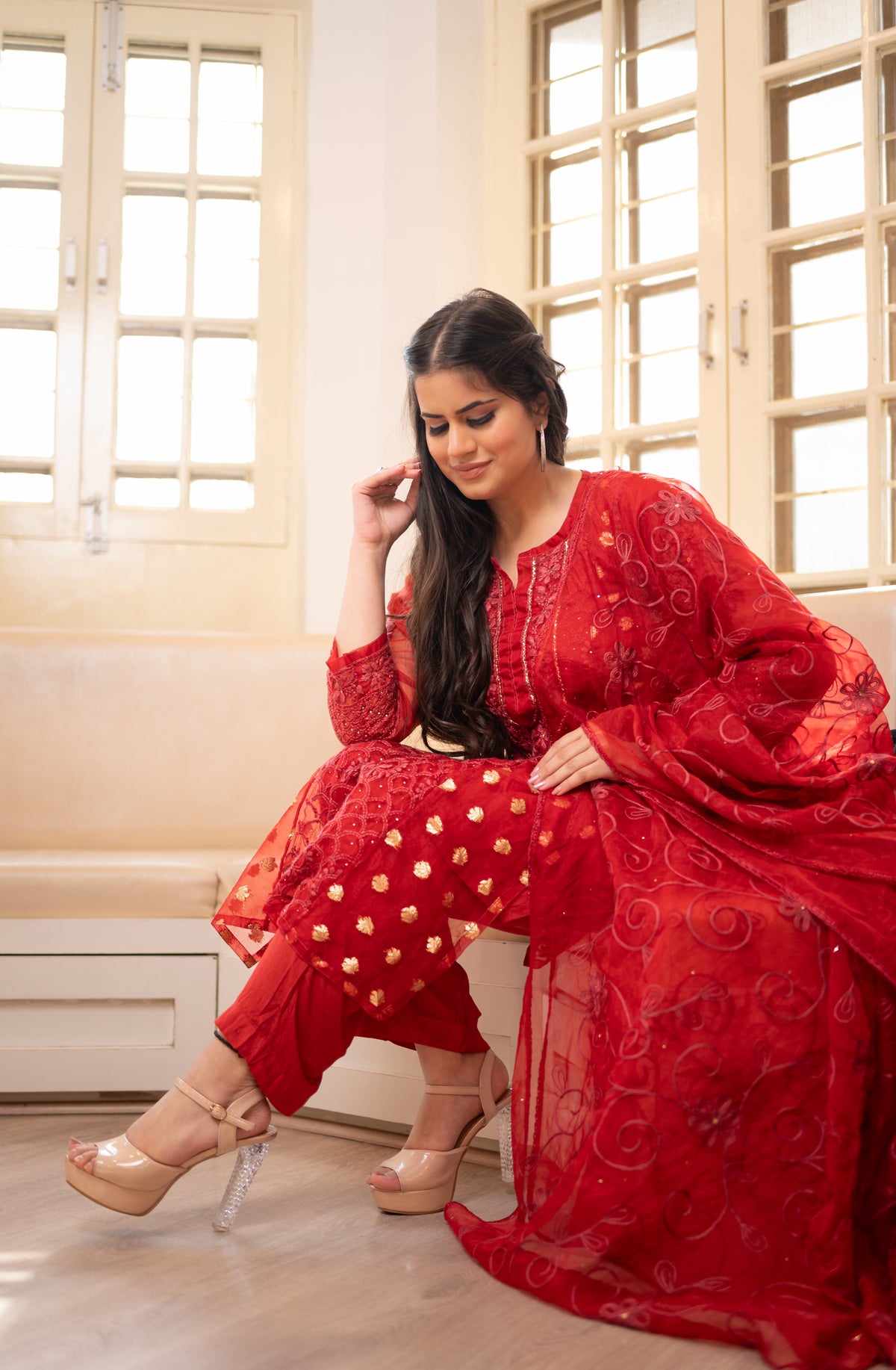 Side view Full red organza salwar kameez with golden accents. View comfortable, elegant Indian women's wear, latest fashion.