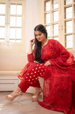 Side view Full red organza salwar kameez with golden accents. View comfortable, elegant Indian women's wear, latest fashion.