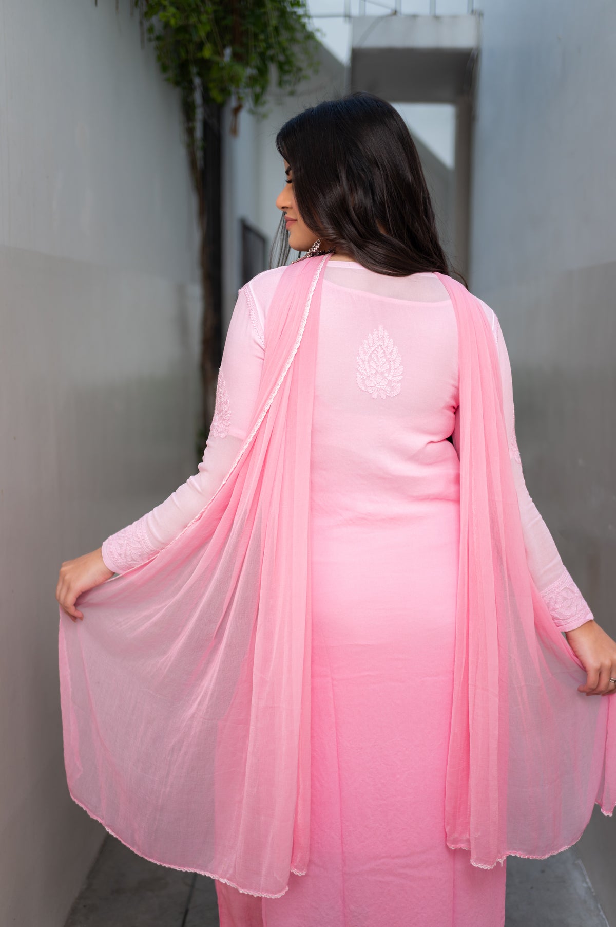 View a lovely Pink Viscose Set. This georgette kurta set features hand-made Chikankari and Mukaish.