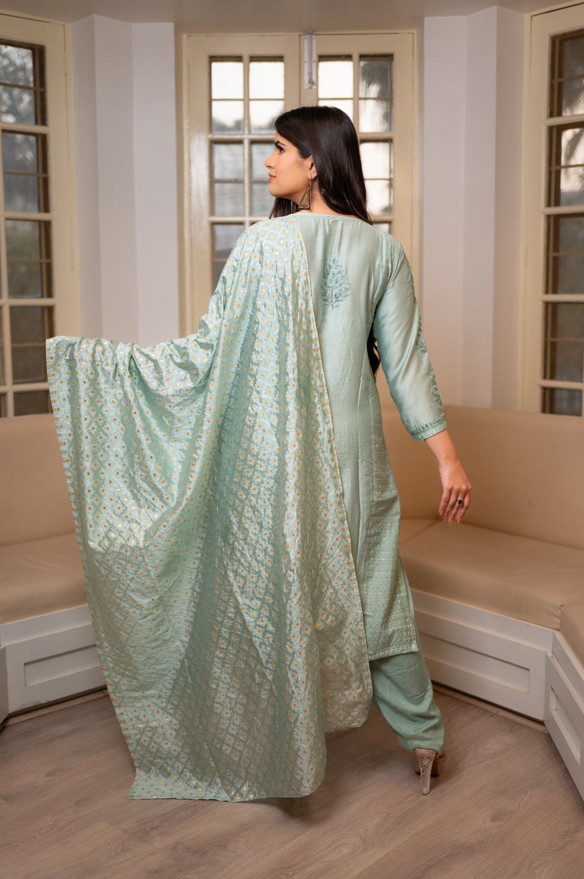 Back view an elegant Green Muslin Chanderi Kurti Set with Chikankari and Zari Cut Dana work.