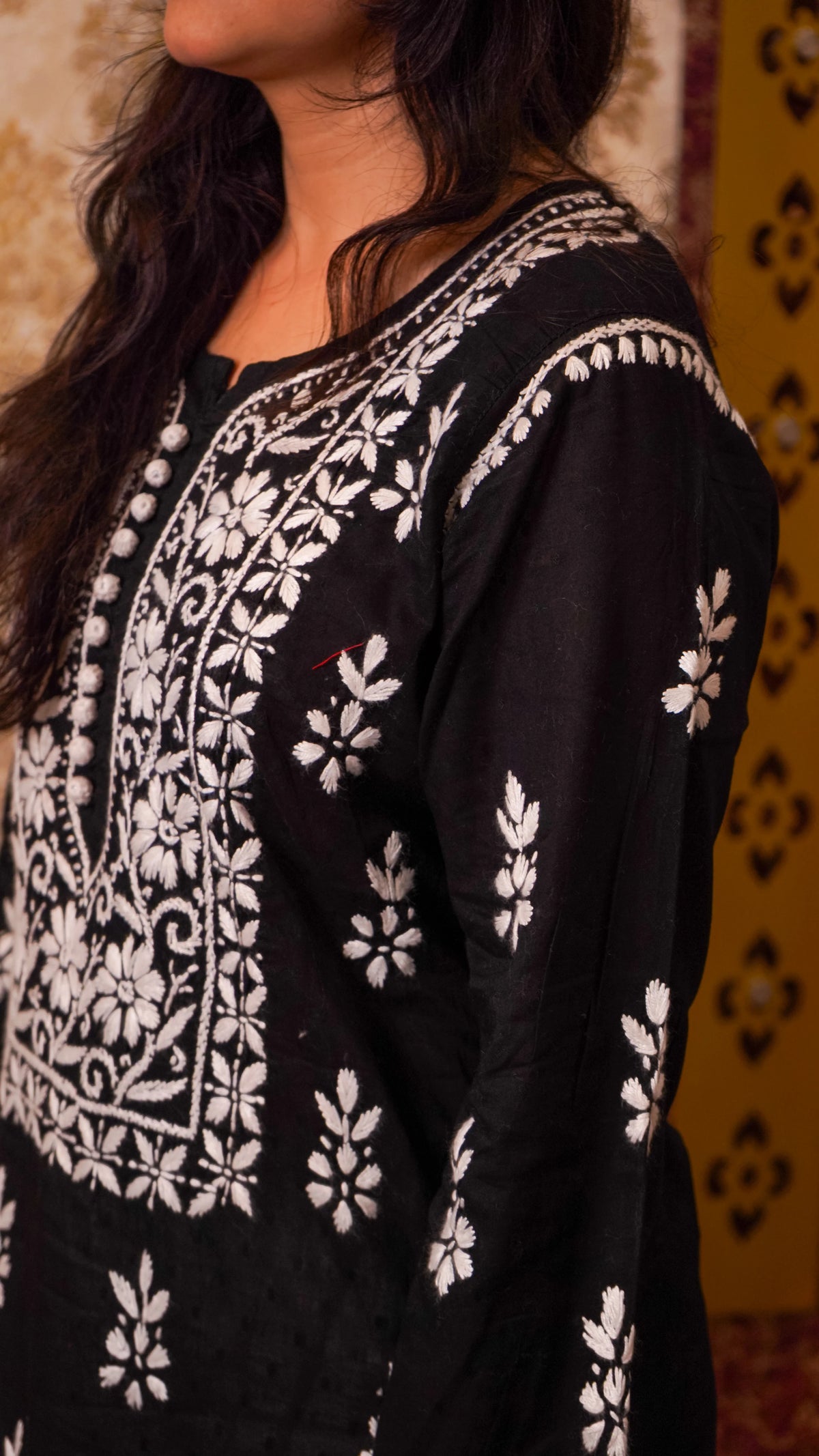 Side view of a black Chikankari kurti, showcasing traditional hand embroidery on soft cotton.