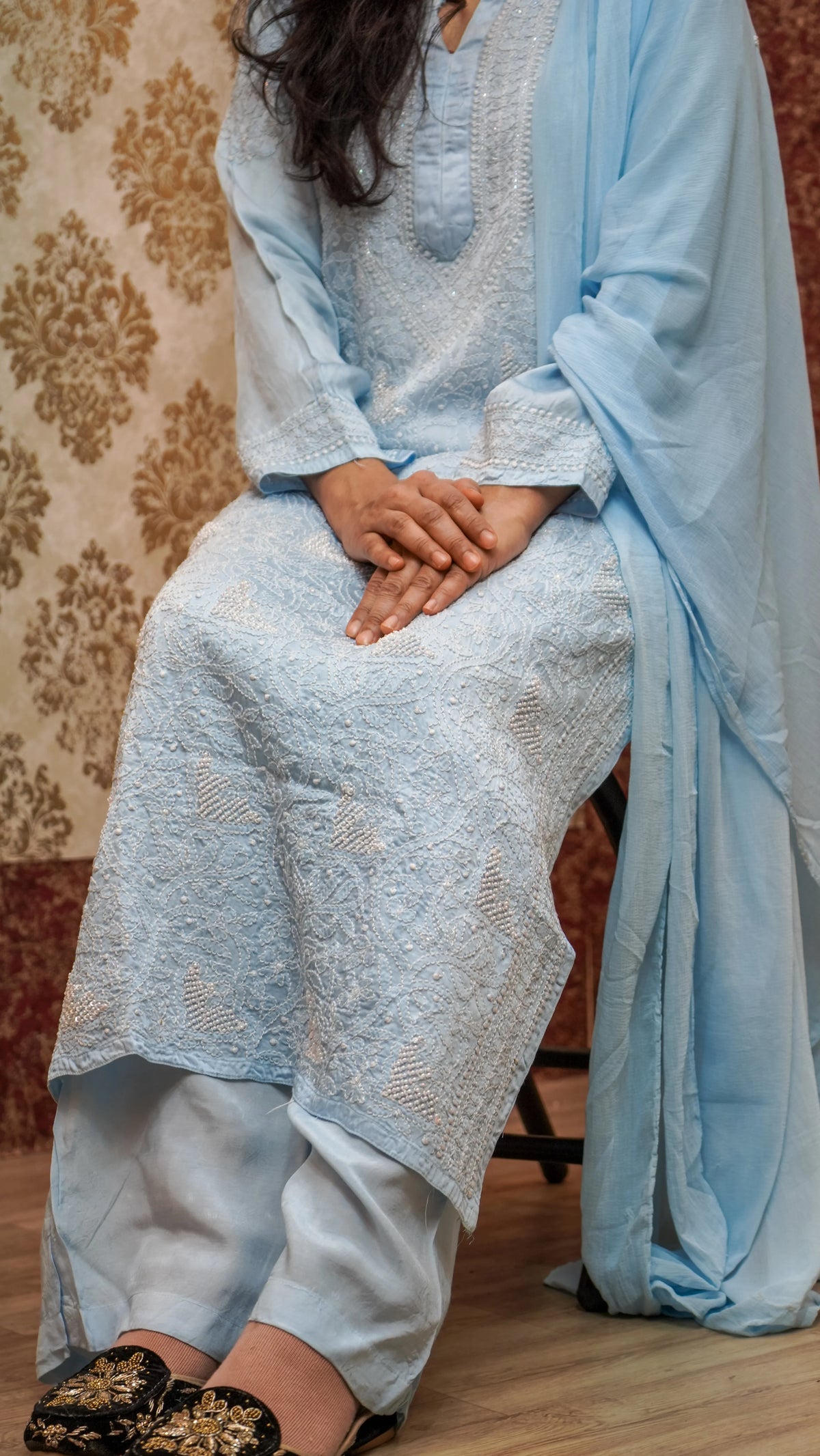 Close-up of Chikankari pearl & sequence work on a sky blue Modal Satin kurti, traditional design.