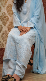 Close-up of Chikankari pearl & sequence work on a sky blue Modal Satin kurti, traditional design.