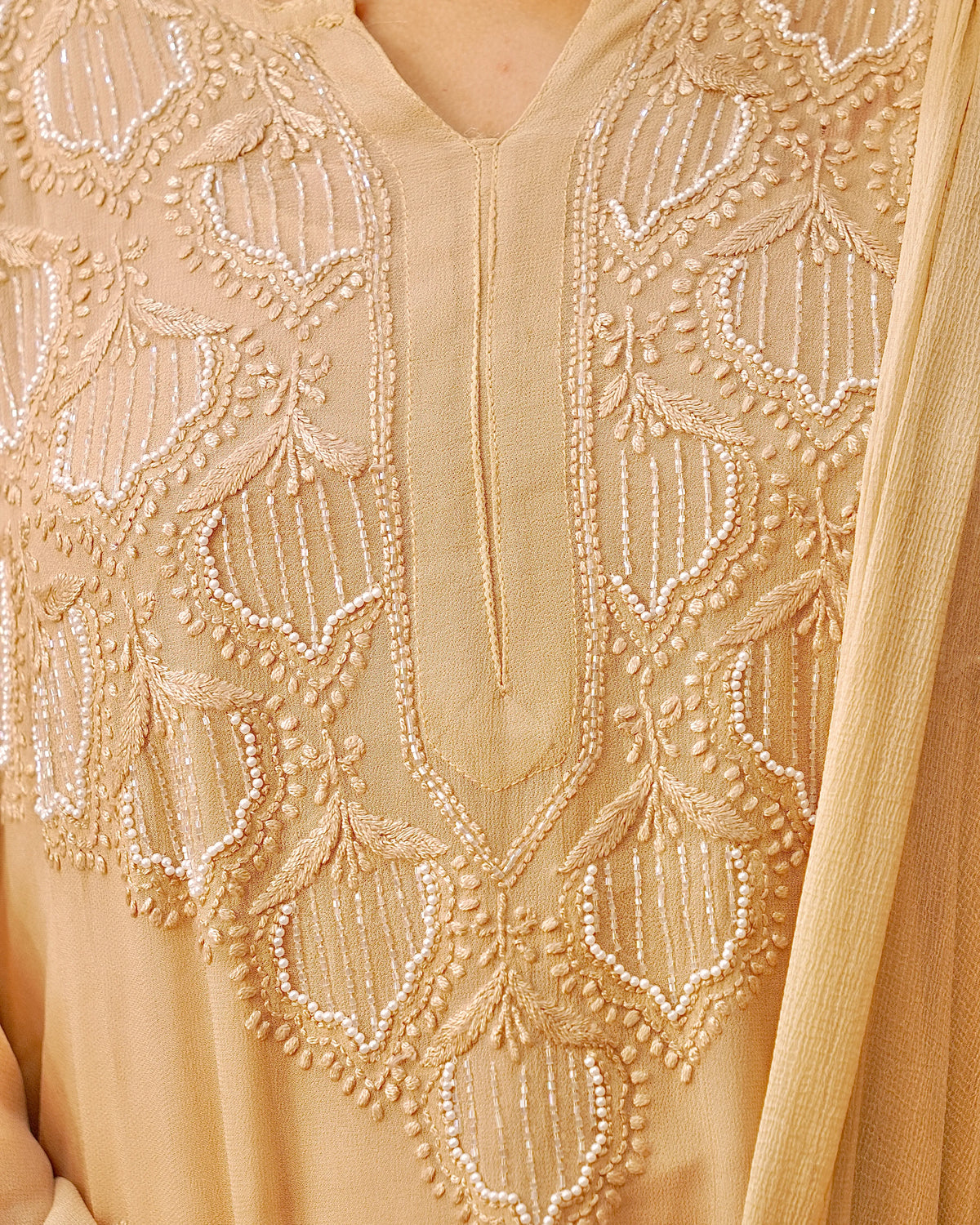 View the breathable viscose georgette fabric of a camel Chikankari Kurta Set, ideal for comfortable ethnic wear.