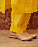 Close-up of fine Chikankari and real mirror work on a white Viscose Georgette Kurti. Luxurious detail.
