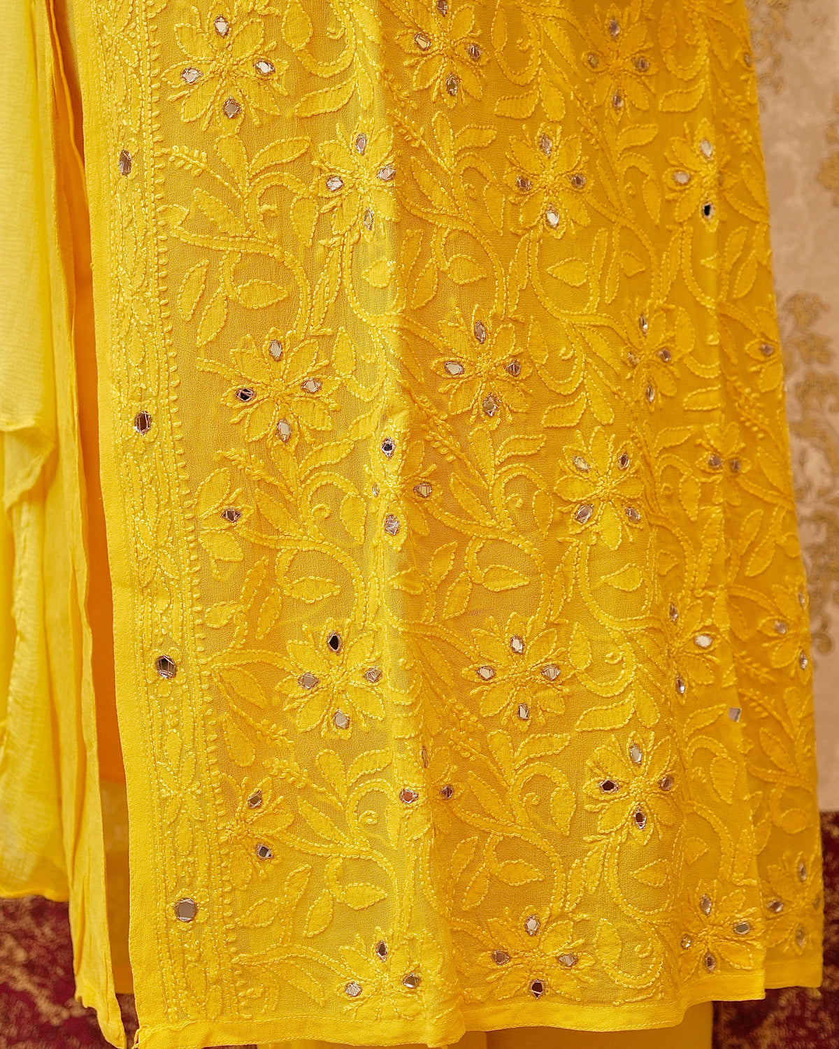 Close-up of the pure viscose georgette fabric and mirror work on a white Viscose Kurta Set.