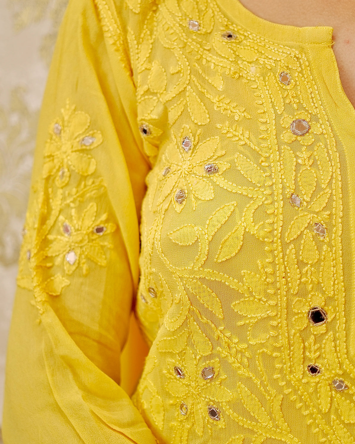 Close-up of breathable viscose georgette fabric from a white Mirror Work Set. Light and comfortable.