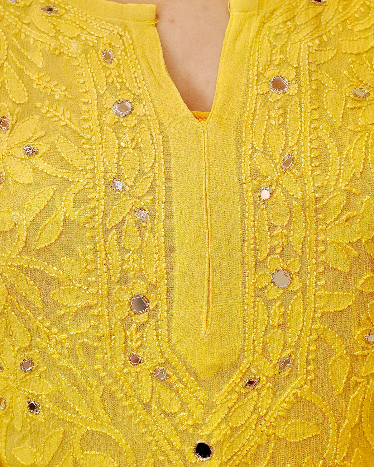 View a white Viscose Mirror Work Georgette Kurta Set, ideal for special occasions. Features hand embroidery.