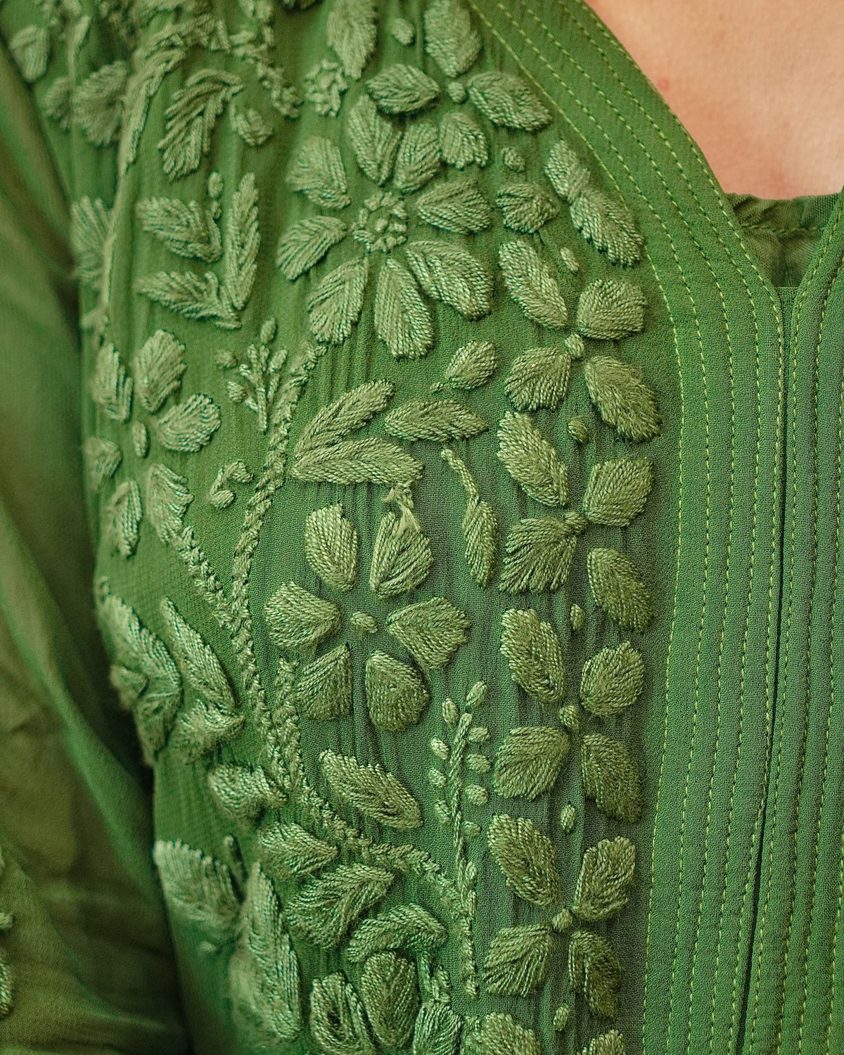 Close-up of unique 3D Chikankari hand embroidery on a green Viscose Georgette Kurti.