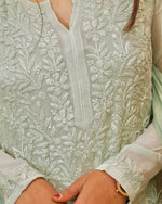 Close-up of the breathable green viscose georgette fabric with exquisite 3D Chikankari and moti work.