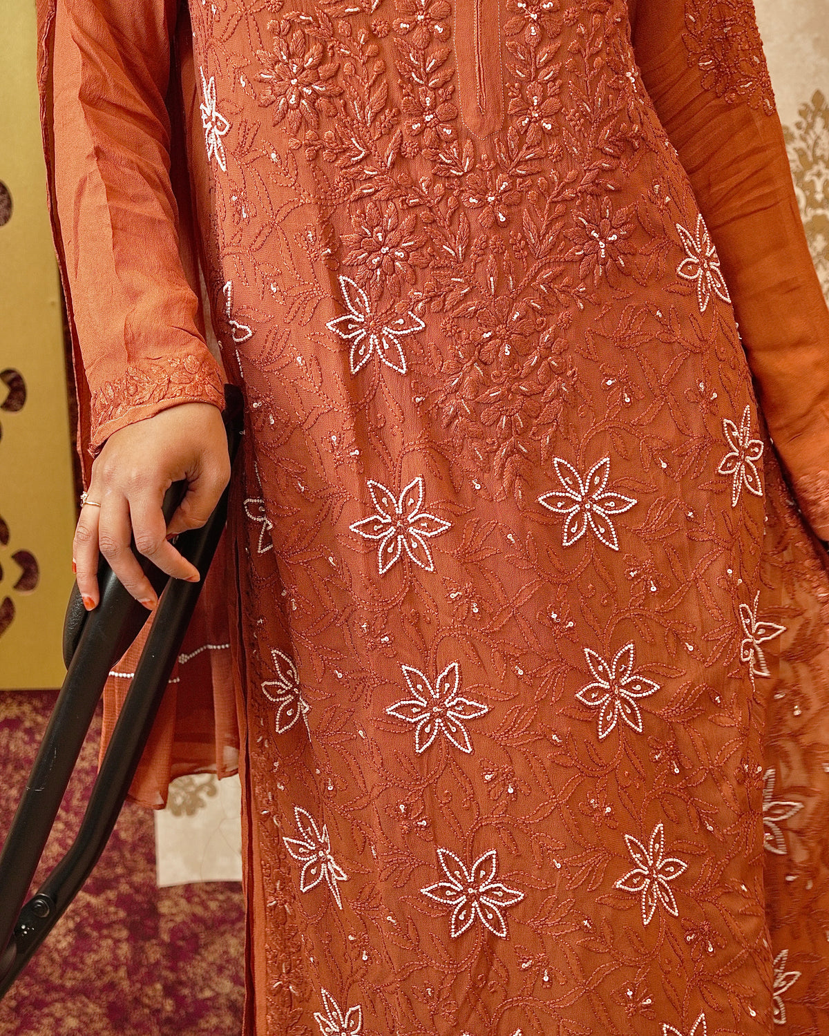 Detailed Zardozi and Chikankari handwork on an orange pure viscose georgette kurti.