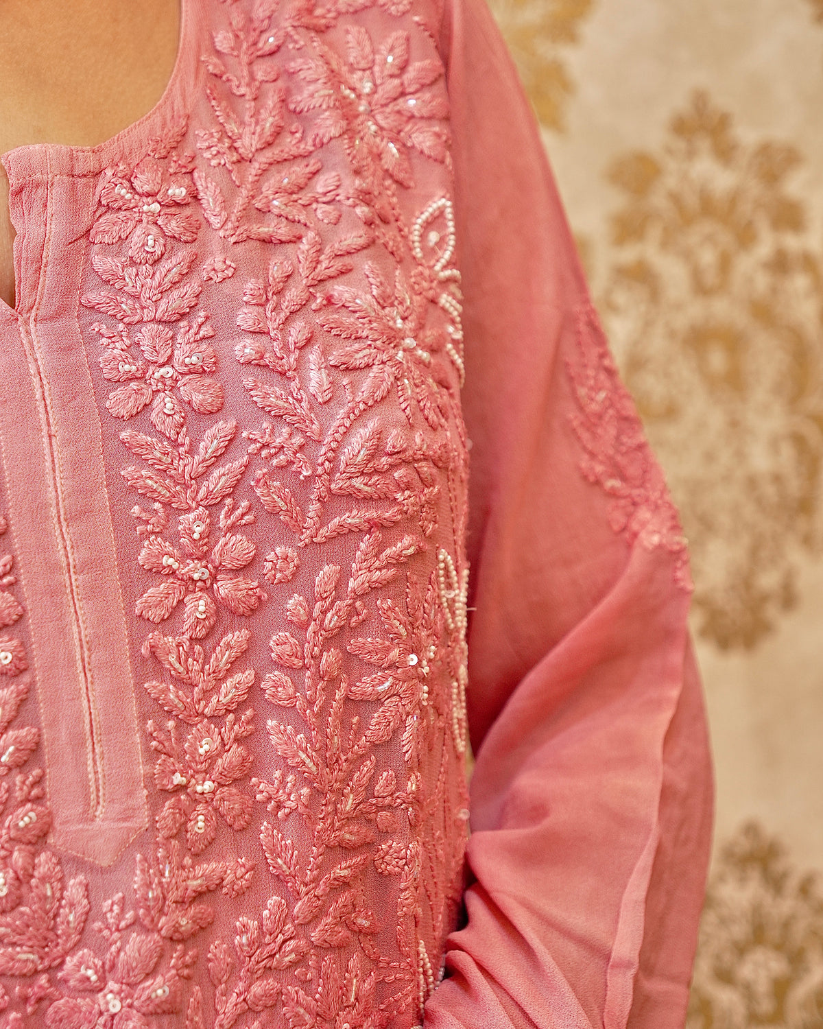 Detailed Lucknowi Chikankari and pearl cut dana embroidery on a Piyazi Pink viscose georgette material.