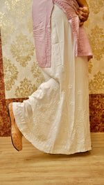 View the graceful drape of a white Kali Palazzo. Features authentic Lucknowi handwork, perfect for ethnic bottom wear.