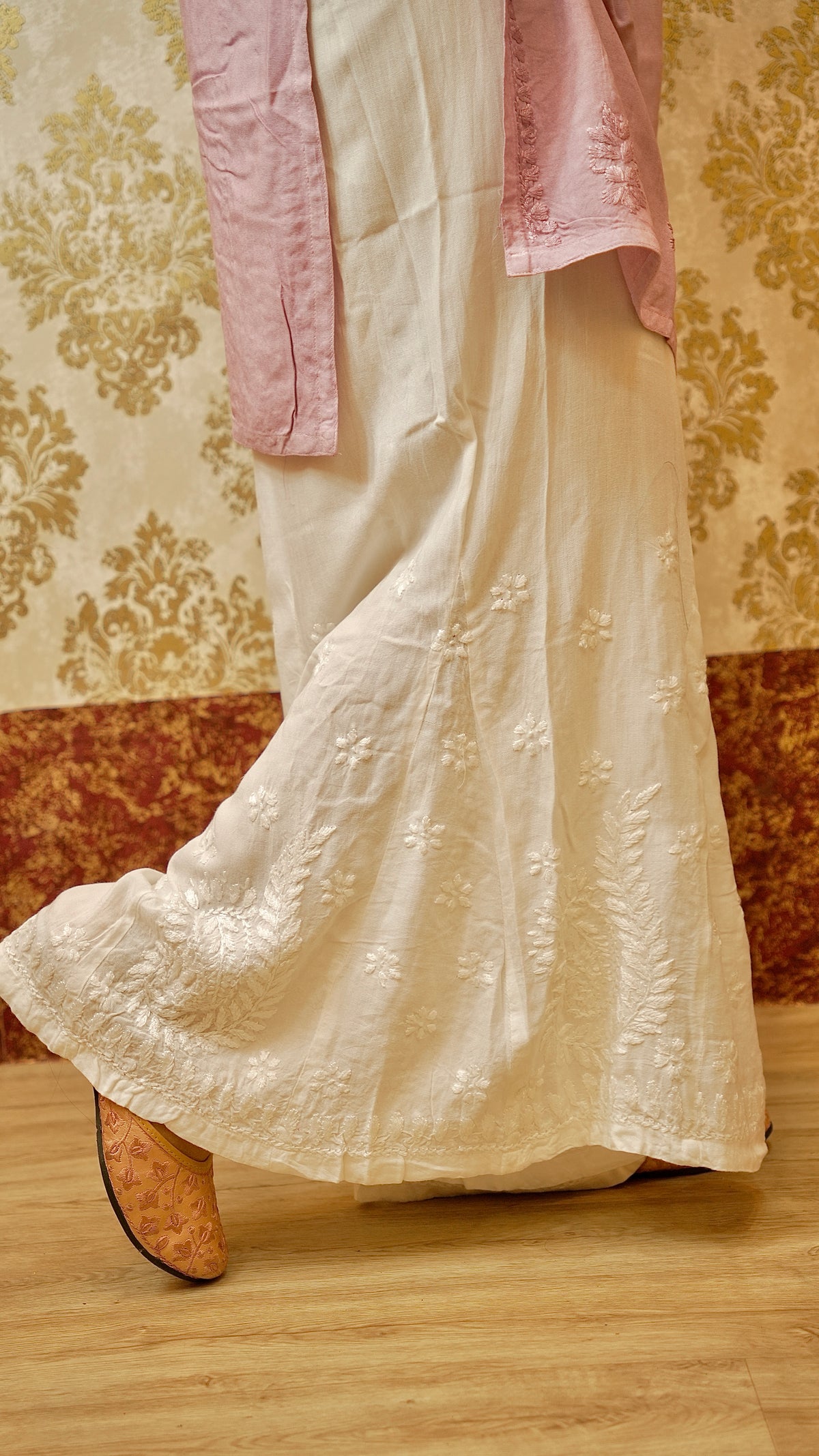 Close-up of detailed Lucknowi handwork on a white Kali Palazzo. Highlights the irritation-free embroidery.