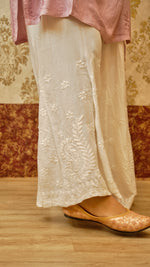 View the long length of a white Kali Palazzo, with its elegant drape and Lucknowi hand embroidery. Stylish bottom wear.