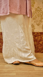 View a comfortable white Kali Palazzo, showcasing its unique cut and Lucknowi handwork. A stylish ethnic bottom wear for women.
