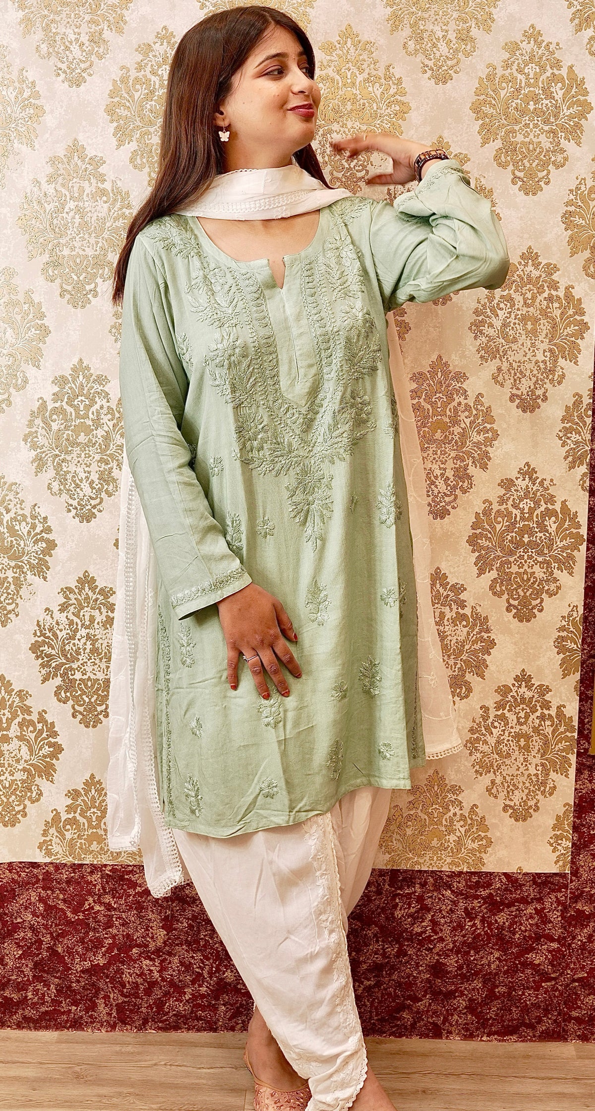Front view of pista green short cotton kurta with white dupatta and pants & with Chikankari embroidery.