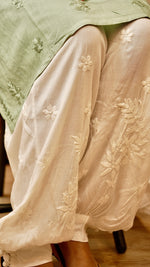 Detailed view of hand-stitched Lucknowi Chikankari on a white Afghani pant. Artistic bottom wear for women.