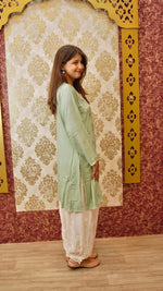 View a long white Afghani pant, perfect for traditional yet trendy Indian wear. Features designer handwork.