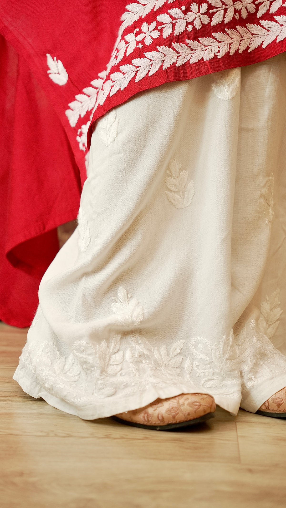 View the elegant drape of a rayon cotton palazzo, with intricate Lucknowi hand embroidery. Modern ethnic bottom wear.