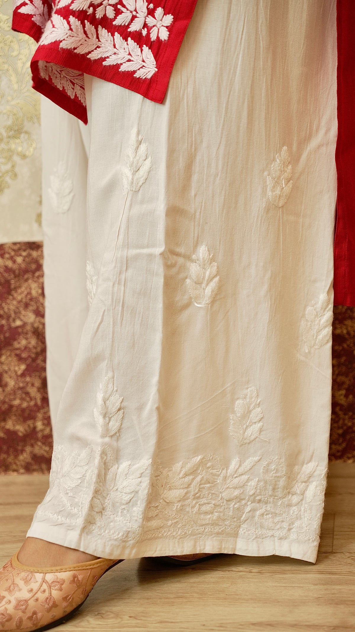 Close-up of the detailed Lucknowi hand embroidery on a flowing rayon cotton palazzo. Exquisite bottom wear.