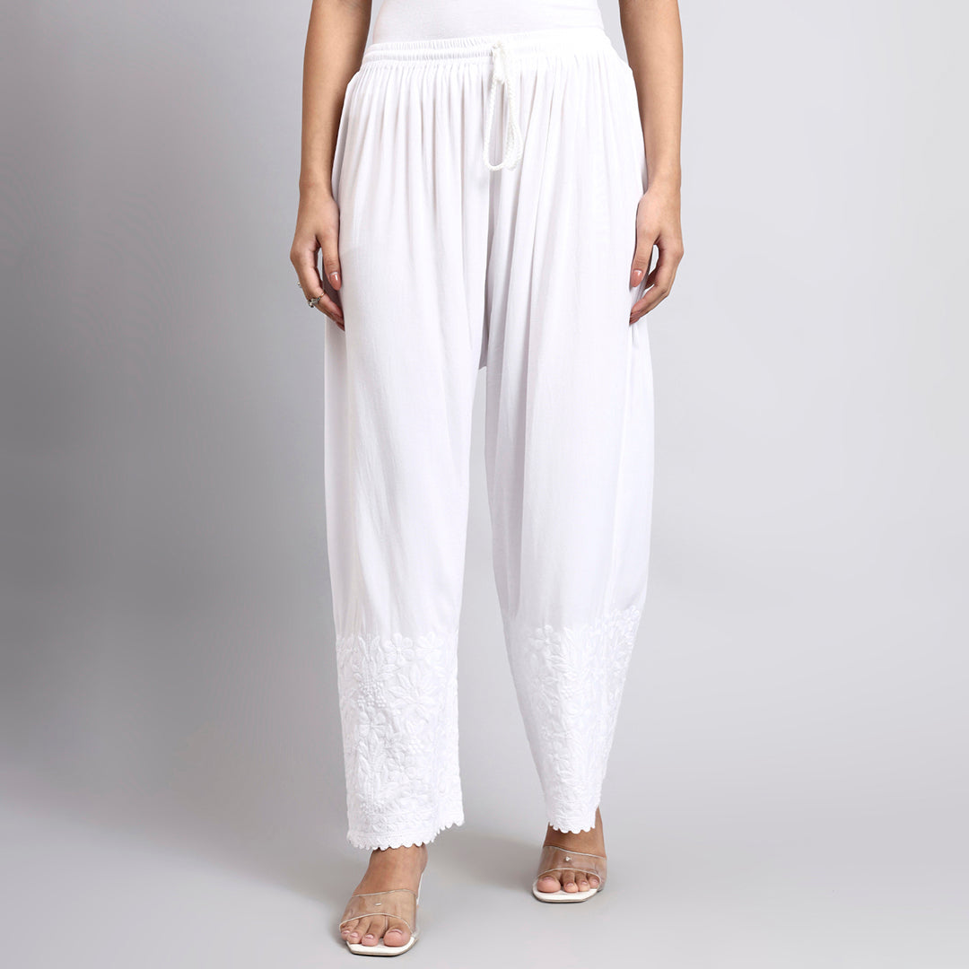 White wide-leg pants worn by a person on a plain background