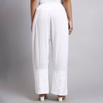 White wide-leg pants worn by a person on a plain background