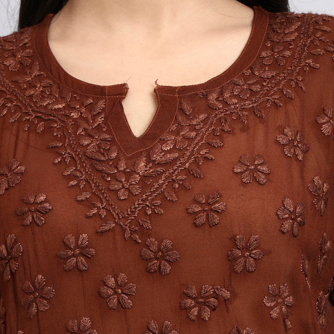 Zoom view of Brown embroidered top with floral patterns on a plain background