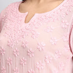 Close-up of a pink embroidered kurta with floral patterns.