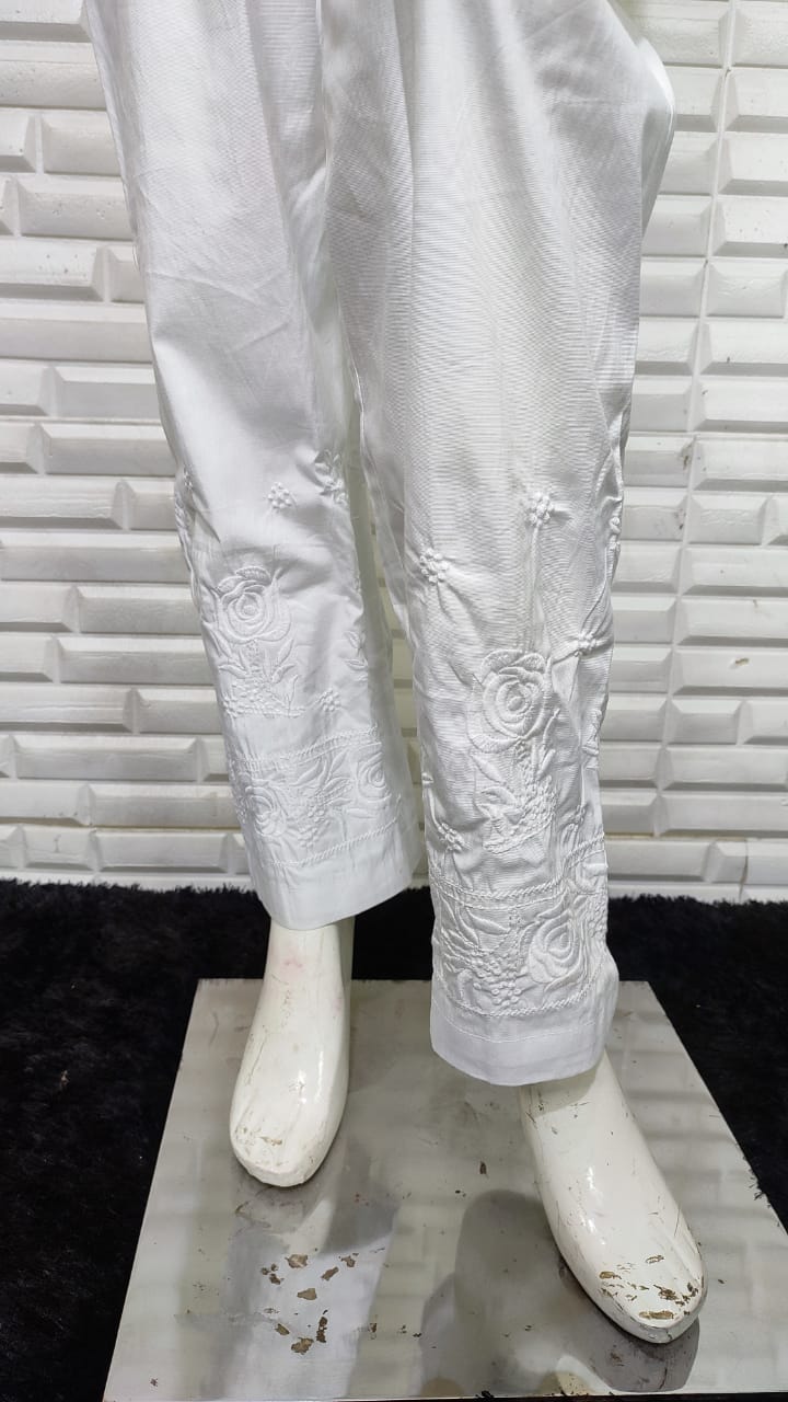 Elegant white Rose Cotton Lycra Pants. Offers comfort fit and flexible fabric, a versatile bottom wear for women.