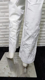 Close-up of crisp white Rose Cotton Lycra Pants fabric with delicate machine embroidery. Breathable bottom pants.