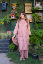 Full shot shows a woman in a pink mulmul kurta that has subtle floral embroidery.