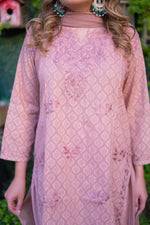 A close-up captures the delicate floral embroidery on a mauve pink mulmul kurta.