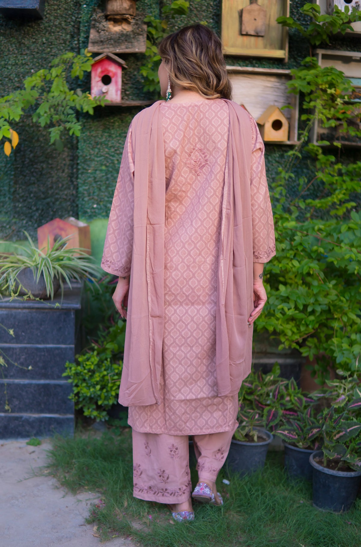 The back view shows a woman in a mauve pink mul cotton fabric kurta and pants with a matching dupatta.