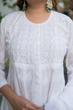 Close-up front view of white anarkali kurta with subtle white-on-white embroidery design on the chest.
