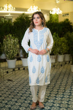White chikankari kurta styled with floral embroidery captured in a front-facing view.