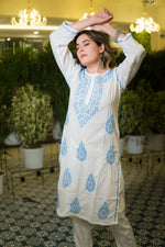 Close-up front shot showing intricate threadwork on a white chikankari kurta.